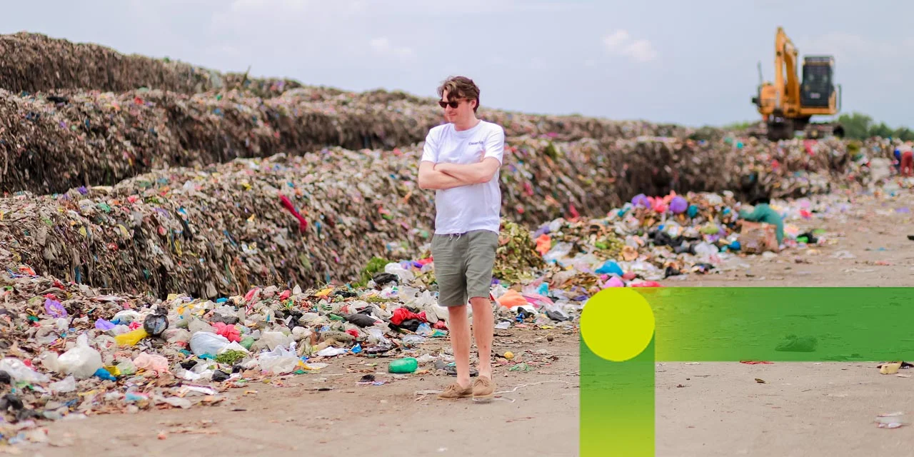Cleanhub: man walking along mountains of waste on the beach