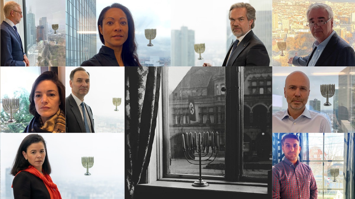 Deutsche Bank Mitarbeiter mit Kieler Chanukka‑Leuchter als Symbol des Erinnerns.